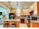 Modern kitchen features stainless steel appliances, a center island and hardwood floors at 3354 Wabash St, Denver, CO 80238