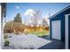 Charming backyard featuring a concrete patio, lawn, wooden fence, and a shed with white door at 1794 Xenia St, Denver, CO 80220