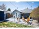 Backyard featuring a patio with outdoor seating, a fire pit, and a lush green lawn at 1794 Xenia St, Denver, CO 80220