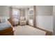 Warm Bedroom with a crib, chair, and two large windows with natural lighting and hardwood floors at 1794 Xenia St, Denver, CO 80220