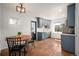 Cozy kitchen with blue cabinets, stainless steel appliances, and adjacent dining space at 1794 Xenia St, Denver, CO 80220