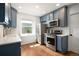 Updated kitchen boasts stainless steel appliances, blue cabinetry, and hardwood floors at 1794 Xenia St, Denver, CO 80220