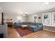 Spacious living room with large sectional sofa, wood floors, and ample natural light at 1794 Xenia St, Denver, CO 80220