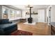 Comfortable living room with hardwood flooring, wood-burning stove, and bright bay window at 1794 Xenia St, Denver, CO 80220