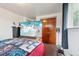Bedroom showcasing closet, TV, and window; comfortable space at 12734 Anhawa Ave, Longmont, CO 80503