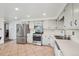 Bright kitchen features stainless steel appliances, ample cabinet space and tile flooring at 12734 Anhawa Ave, Longmont, CO 80503