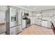 Bright kitchen features stainless steel appliances, ample cabinet space and tile flooring at 12734 Anhawa Ave, Longmont, CO 80503