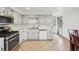 Open-concept kitchen has tile flooring and access to backyard at 12734 Anhawa Ave, Longmont, CO 80503