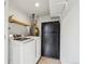 Laundry room featuring washer, dryer, refrigerator, and utility shelving at 12734 Anhawa Ave, Longmont, CO 80503