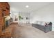 Bright living room with fireplace, shelves, and comfortable sofa at 12734 Anhawa Ave, Longmont, CO 80503