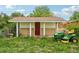 Exterior shed with a red door, surrounded by grass and a lawnmower at 12734 Anhawa Ave, Longmont, CO 80503