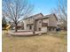 Spacious backyard with a brick patio, a playhouse, and mature trees, perfect for outdoor entertaining and Gathering fun at 11254 Oakland Dr, Commerce City, CO 80640
