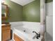 Bathroom featuring a soaking tub with tile surround and a glass enclosed shower at 11254 Oakland Dr, Commerce City, CO 80640