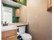 Half bathroom featuring neutral colors, wood vanity, toilet, and mirror at 11254 Oakland Dr, Commerce City, CO 80640
