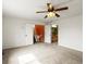 Bright carpeted bedroom with fan and an open doorway to a bathroom and stairway at 11254 Oakland Dr, Commerce City, CO 80640