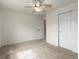This bedroom is bright with neutral carpet, a ceiling fan, and a closet at 11254 Oakland Dr, Commerce City, CO 80640