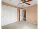 Neutral bedroom featuring carpet and large closet with ceiling fan and light at 11254 Oakland Dr, Commerce City, CO 80640