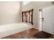 Bright entry featuring soaring ceilings, large windows with curtains, hardwood flooring, and a front door at 11254 Oakland Dr, Commerce City, CO 80640