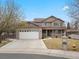 Charming two-story home featuring an attached two-car garage, inviting porch, and manicured front lawn at 11254 Oakland Dr, Commerce City, CO 80640
