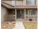 Inviting covered front porch with decorative details and manicured landscaping welcomes you home at 11254 Oakland Dr, Commerce City, CO 80640