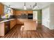 Eat-in kitchen featuring stainless steel appliances, wood cabinets, an island, and ample counter space at 11254 Oakland Dr, Commerce City, CO 80640
