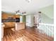 Spacious open concept kitchen area with an island, modern lighting, and stairs to the second floor at 11254 Oakland Dr, Commerce City, CO 80640