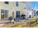 Backyard featuring a patio, sliding glass doors, a grill, and a small grassy area at 3295 S Estes St, Lakewood, CO 80227