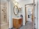 Bathroom featuring a shower with glass door, vanity and oval mirror at 3295 S Estes St, Lakewood, CO 80227