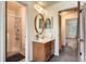 A bathroom features a vanity with framed mirror, and walk-in shower at 3295 S Estes St, Lakewood, CO 80227