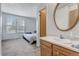 Bedroom with en-suite bathroom with wood cabinet sink at 3295 S Estes St, Lakewood, CO 80227