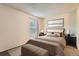 Serene bedroom with a cushioned bench and natural light at 3295 S Estes St, Lakewood, CO 80227