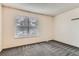 A bright bedroom features a window and neutral carpet at 3295 S Estes St, Lakewood, CO 80227