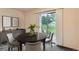 Dining room with a round table, stylish chairs, and sliding glass door at 3295 S Estes St, Lakewood, CO 80227