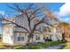 Exterior view of townhouses on a tree lined street with well-manicured lawns at 3295 S Estes St, Lakewood, CO 80227