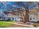Exterior street view of townhouses featuring beautiful lawns and mature trees at 3295 S Estes St, Lakewood, CO 80227