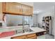 Kitchen view featuring stainless steel sink and view to living area at 3295 S Estes St, Lakewood, CO 80227