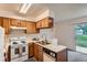 Cozy kitchen featuring bright appliances and laminate countertop at 3295 S Estes St, Lakewood, CO 80227