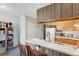 Kitchen space featuring breakfast bar, ample cabinets, and essential appliances at 3295 S Estes St, Lakewood, CO 80227