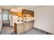 Functional kitchen with laminate countertops and wooden cabinetry at 3295 S Estes St, Lakewood, CO 80227