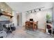 Open-concept living room featuring a stone fireplace and dining area at 3295 S Estes St, Lakewood, CO 80227