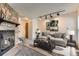 Cozy living room featuring a stone fireplace and neutral decor at 3295 S Estes St, Lakewood, CO 80227