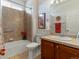 This bathroom includes a bathtub with tiled shower and vanity with a sink at 22647 Hopewell Ave, Parker, CO 80138