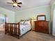 This bedroom features a large bed, a wood dresser and a view into the bathroom at 22647 Hopewell Ave, Parker, CO 80138