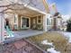 Comfortable covered patio featuring outdoor seating and views of the landscaped backyard with mature trees at 22647 Hopewell Ave, Parker, CO 80138