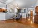 Dining room featuring hardwood floors, modern chandelier, view to living room and front entryway at 22647 Hopewell Ave, Parker, CO 80138