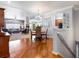 Open concept dining room with hardwood floors flowing into a cozy living area and stylish lighting at 22647 Hopewell Ave, Parker, CO 80138