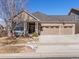 Charming single-story home featuring a brick facade, a three car garage, and a well-manicured front yard at 22647 Hopewell Ave, Parker, CO 80138