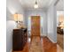 Welcoming foyer with hardwood floors, a stylish console table, and a view of the bedroom at 22647 Hopewell Ave, Parker, CO 80138