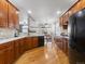 Kitchen featuring wood cabinets, modern appliances, an island, hardwood floors and an adjacent dining area at 22647 Hopewell Ave, Parker, CO 80138