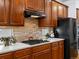 Kitchen featuring wood cabinets, granite countertops, stainless appliances and decorative tile backsplash at 22647 Hopewell Ave, Parker, CO 80138